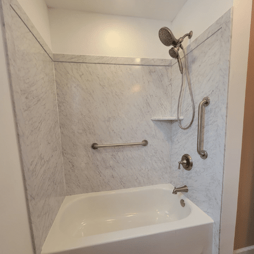 Updated bathroom remodel with new shower, tile, and fixtures by Homes by Covenant in Central New York