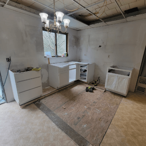 Kitchen before renovation showing partial demolition and preparation work by Homes by Covenant