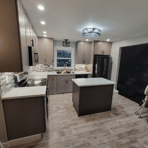 Modern kitchen renovation featuring island, updated cabinetry, and lighting by Homes by Covenant