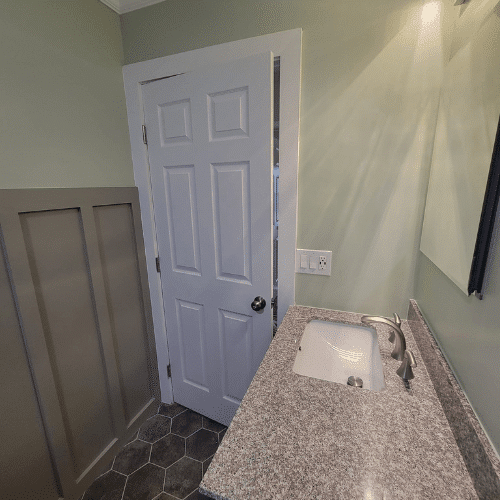 Vanity installation in newly remodeled bathroom completed by Homes by Covenant interior renovation team