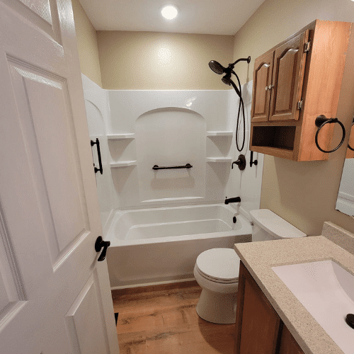 Newly remodeled bathroom featuring updated vanity, flooring, and lighting by Homes by Covenant