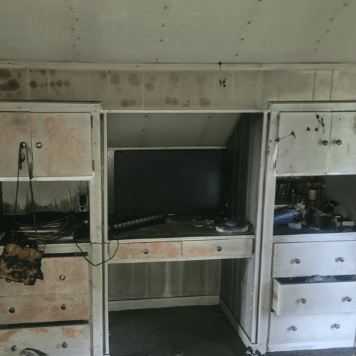 Fire-damaged interior showing smoke stains and debris before restoration by Homes by Covenant