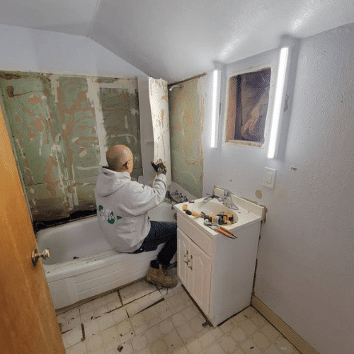 Bathroom renovation work in progress showing wall removal and preparation by Homes by Covenant