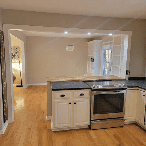Completed kitchen remodel with stainless steel appliances and hardwood flooring by Homes by Covenant