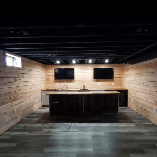 Rustic wood-paneled basement interior completed by Homes by Covenant renovation division