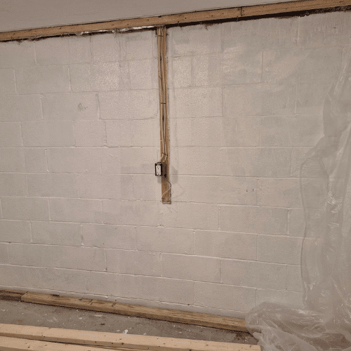 Basement renovation in progress with insulation and wall framing by Homes by Covenant construction team