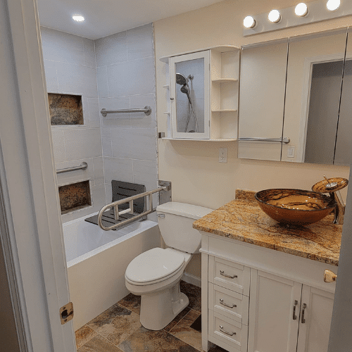 Bathroom renovation in progress showing drywall repair and plumbing updates by Homes by Covenant`