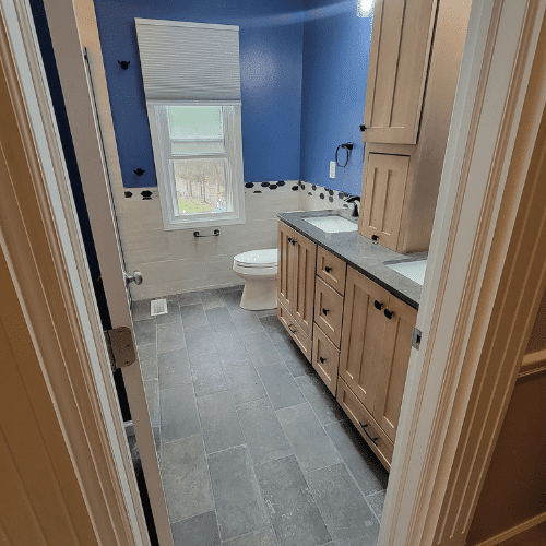 Full view of completed bathroom renovation showing custom vanity and walk-in shower by Homes by Covenant