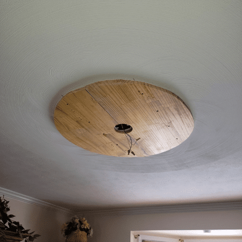 Custom wood light fixture installed in renovated home by Homes by Covenant construction team