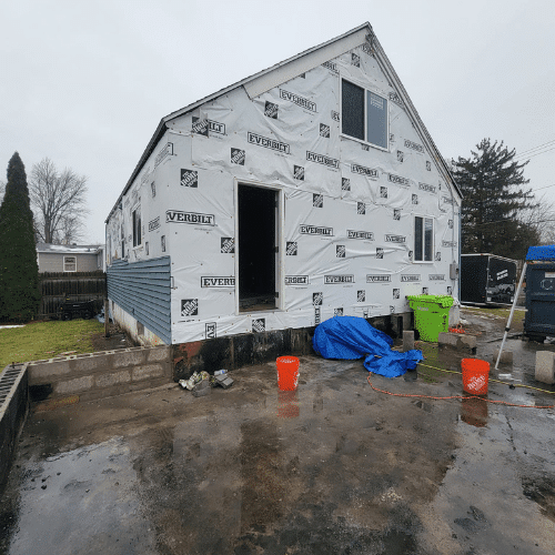 Exterior renovation and siding installation project in progress by Homes by Covenant