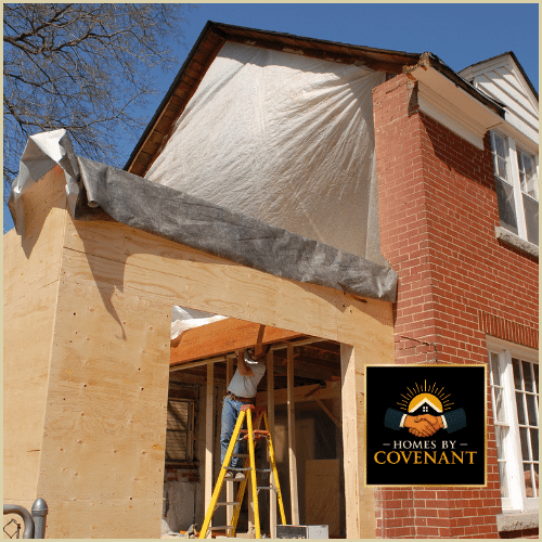 Exterior addition under construction with new framing, roof work, and structural expansion.