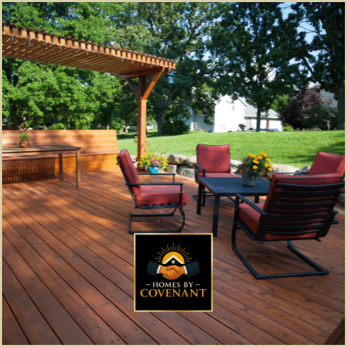 Finished outdoor deck with seating and railing overlooking yard.